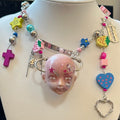 Y2K Decora Pink Doll Face Necklace with Smiley Star, Strawberry & Razor Blade Charms - Crux Jewelry product image 1