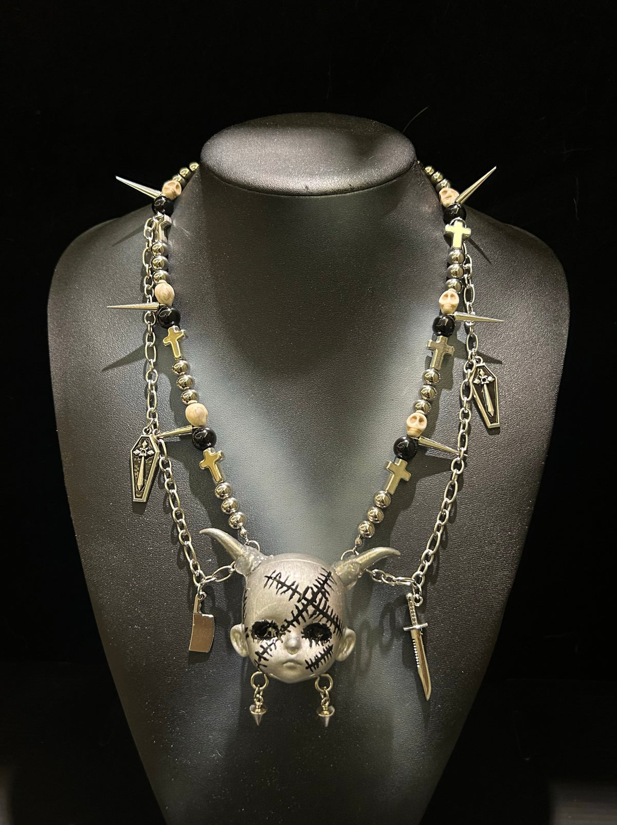 Silver Horned Stitched Doll Face Necklace with Cleaver, Knife & Coffin Charms - Crux Jewelry product image 1