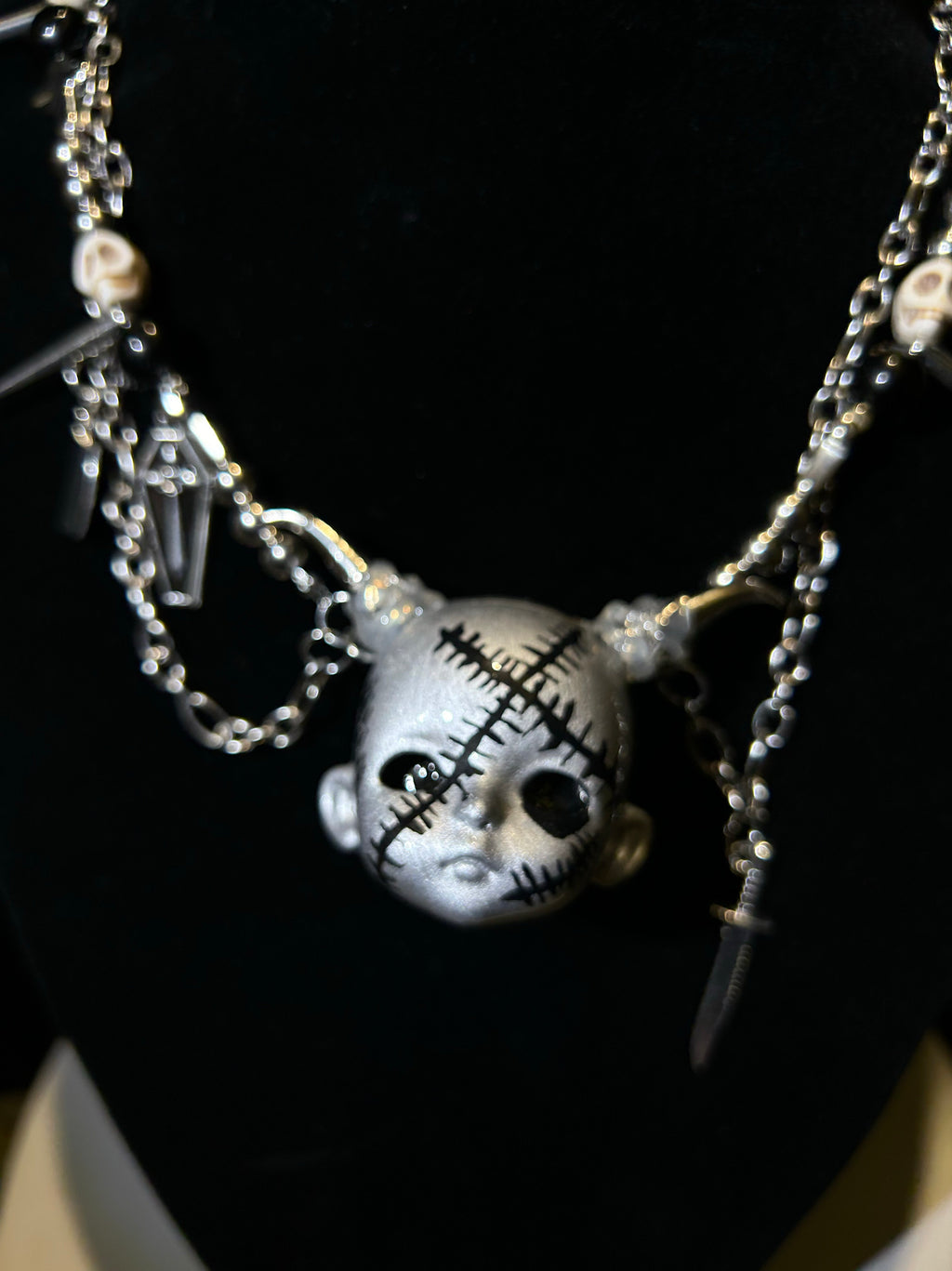 Silver Horned Stitched Doll Face Necklace with Cleaver, Knife & Coffin Charms - Crux Jewelry product image 3