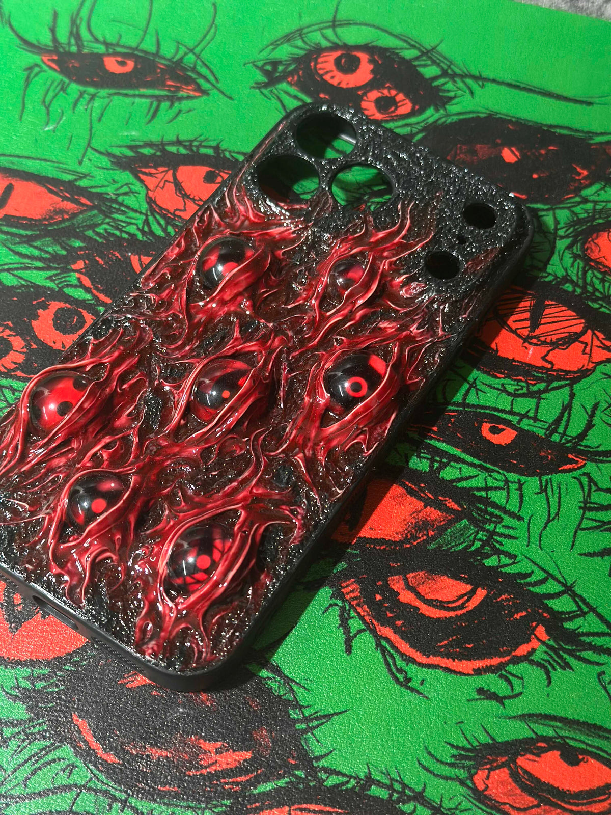 Uchiha Nightmare: Handmade Red Flesh Case with Multiple Sharingan Eyes (3D Texture) - Crux Jewelry product image 3