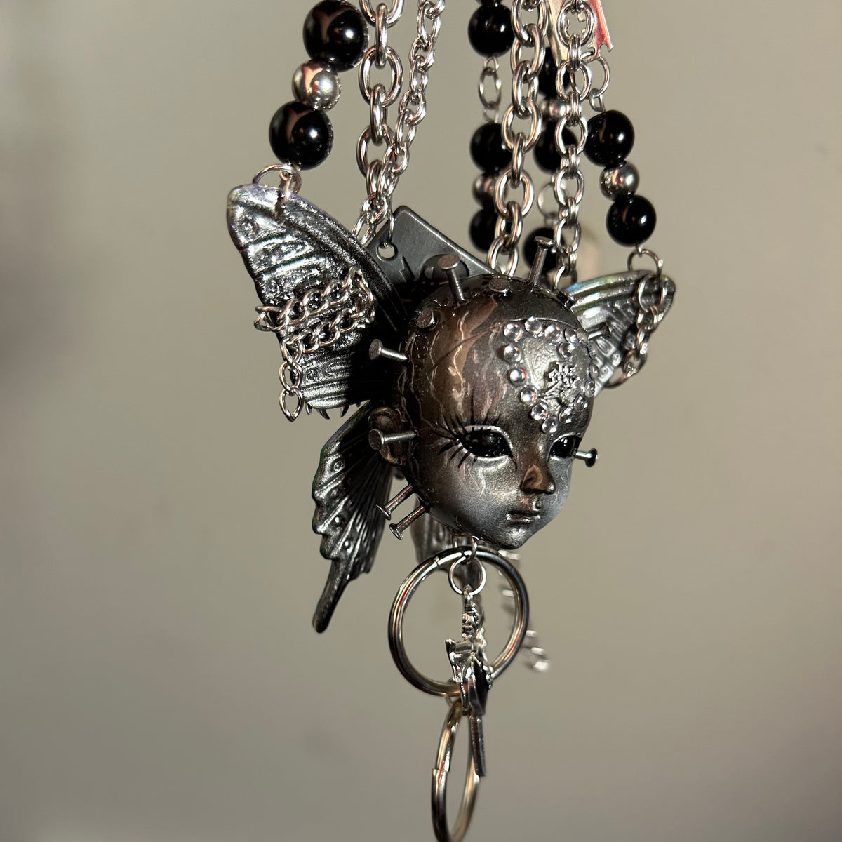 Silver Metallic Butterfly Doll Face Necklace with Rhinestone Heart & Winged Skull Charm - Crux Jewelry product image 8