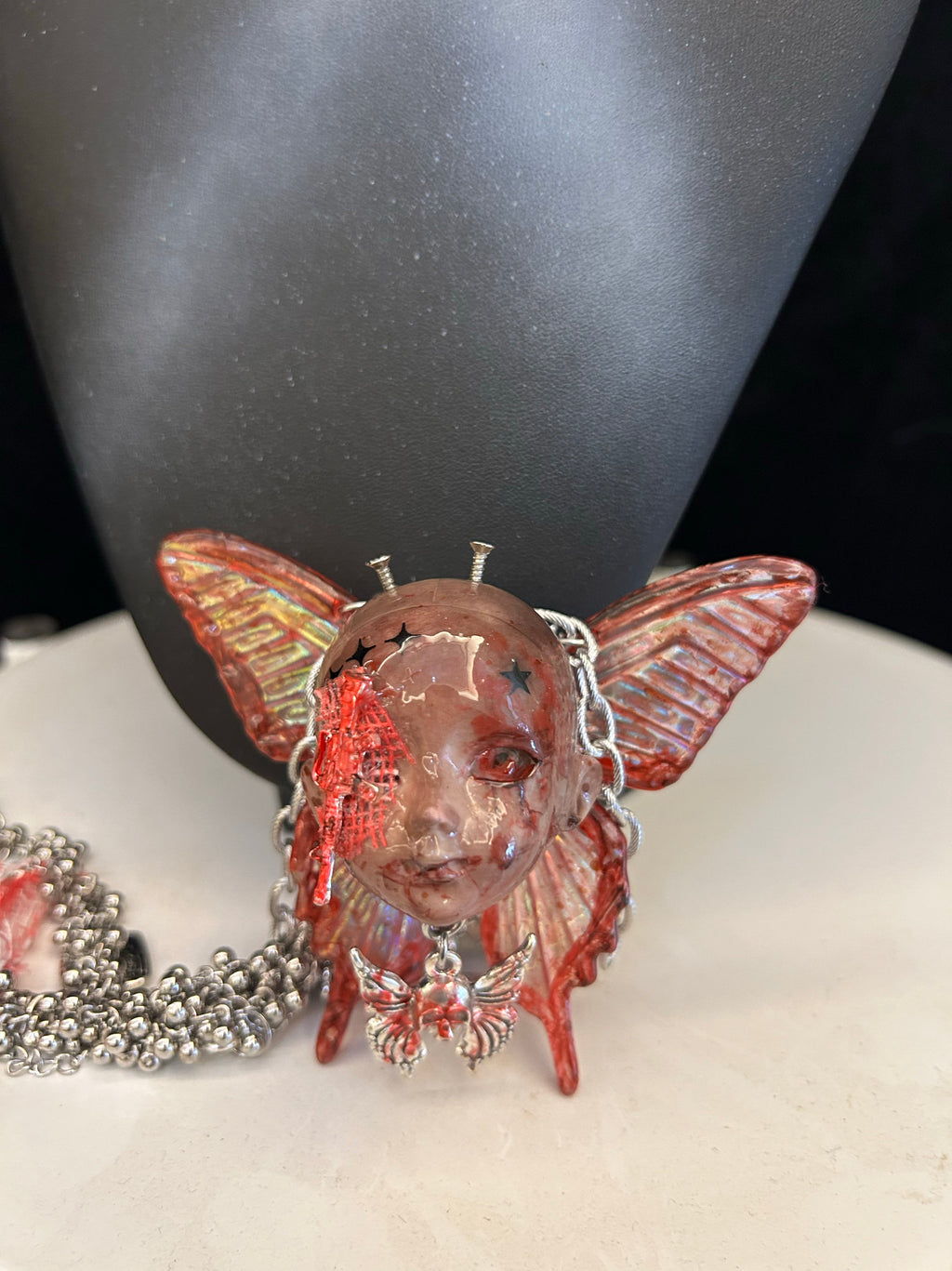 Menhera Bloody Injured Doll Face Necklace with Syringe & Revolver Charms - R - Crux Jewelry product photo