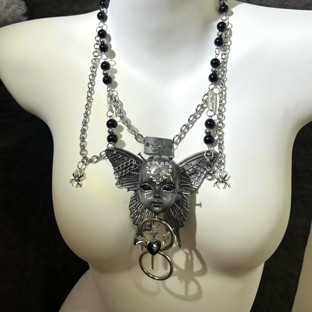 Silver Metallic Butterfly Doll Face Necklace with Rhinestone Heart & Winged Skull Charm - Crux Jewelry product image 5
