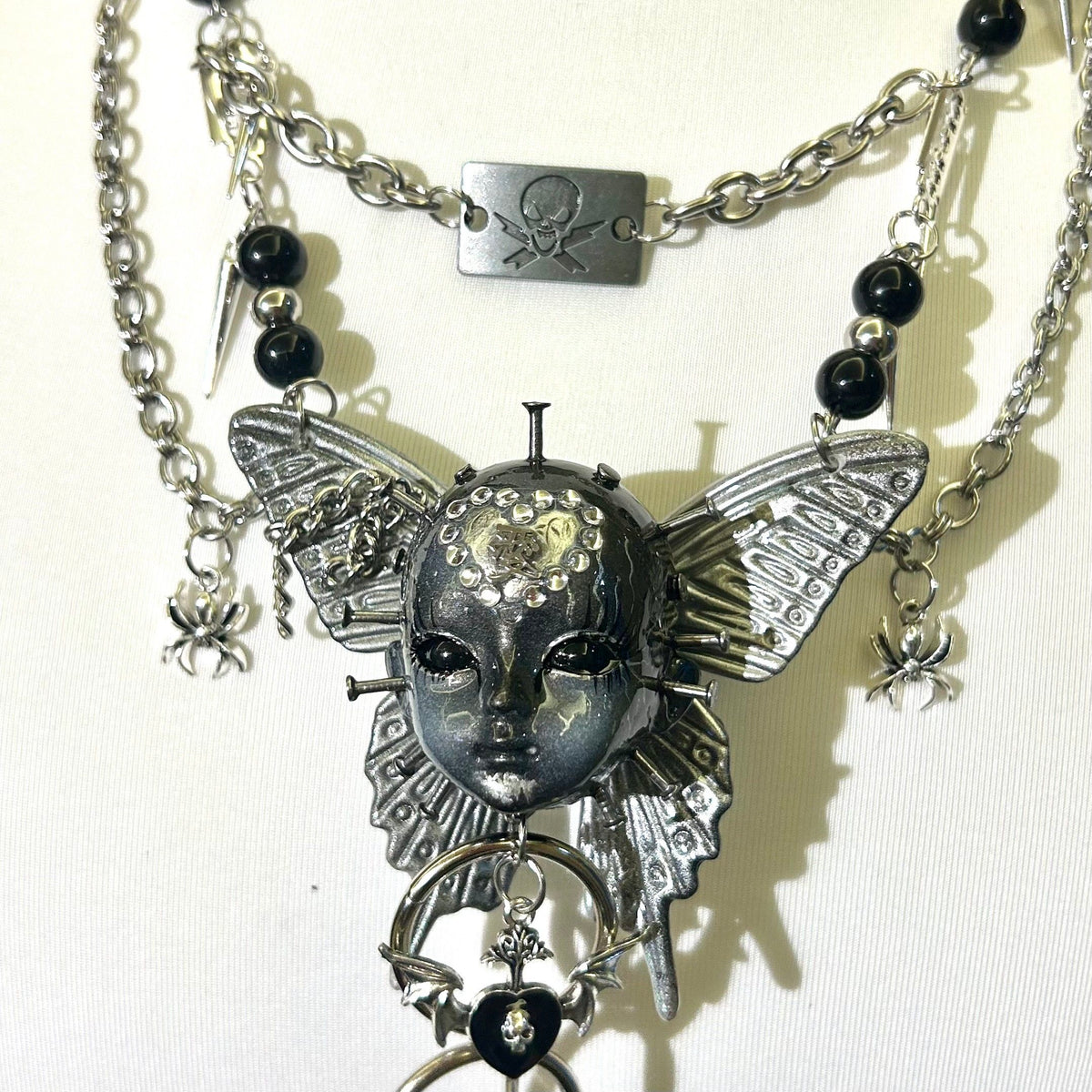 Silver Metallic Butterfly Doll Face Necklace with Rhinestone Heart & Winged Skull Charm - Crux Jewelry product image 3